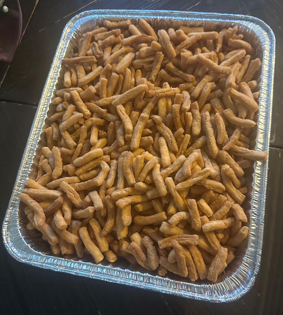 freshly fried African snack in a large aluminium tray